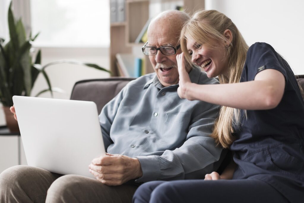 smiley-old-man-nurse-having-video-call-laptop - Copy